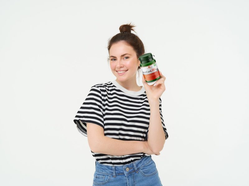 healthcare-wellbeing-young-woman-holding-bottle-with-vitamins-dietary-supplements-treatment